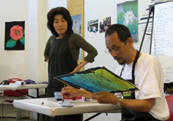 Tange-san demonstrates dyeing lines etched in wax (scrafitto).